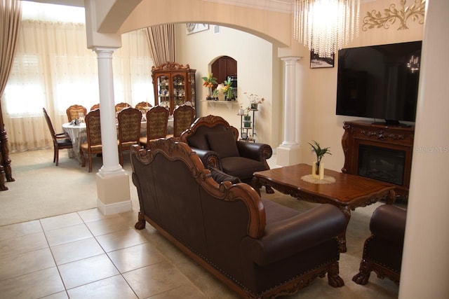 2851 Swoop Cir, Kissimmee, FL 34741 - living area featuring decorative columns, light carpet, arched walkways, light tile patterned flooring, and crown molding