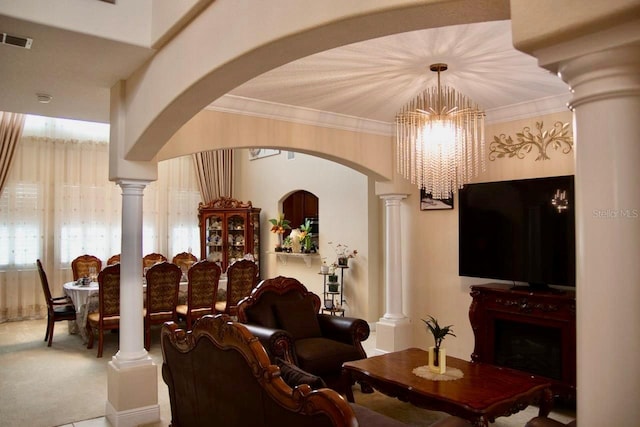 2851 Swoop Cir, Kissimmee, FL 34741 - living room featuring a chandelier, ornate columns, arched walkways, carpet, and crown molding
