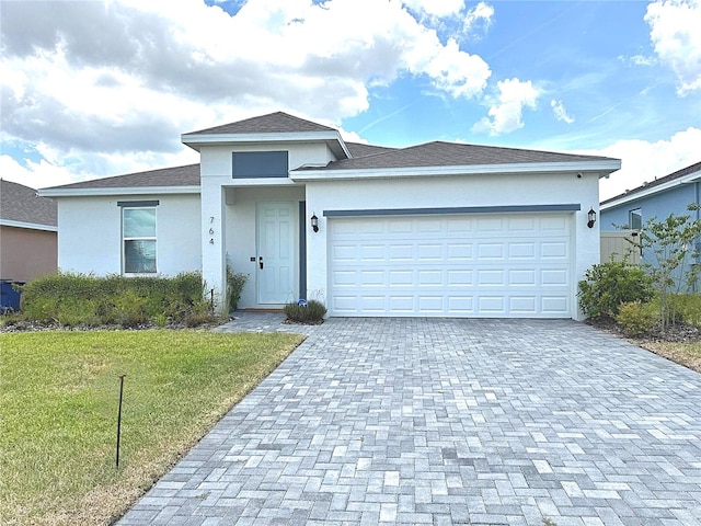 764 Richmond Estate Ave, Haines City, FL 33844 - single story home featuring a garage, stucco siding, a front lawn, decorative driveway, and roof with shingles