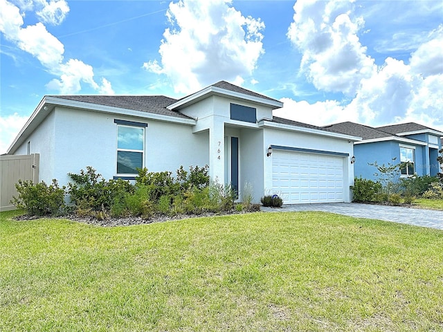 764 Richmond Estate Ave, Haines City, FL 33844 - view of front of property with a garage, decorative driveway, and stucco siding