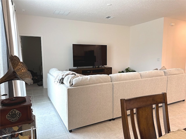 764 Richmond Estate Ave, Haines City, FL 33844 - living room with light tile patterned floors and a textured ceiling