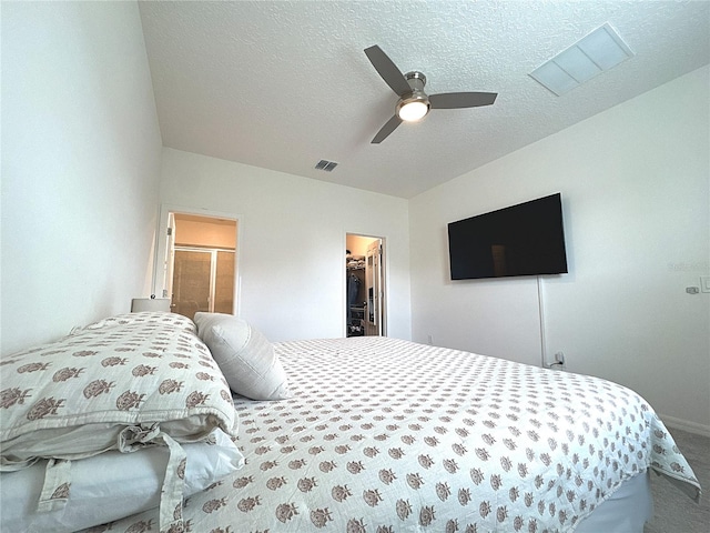 764 Richmond Estate Ave, Haines City, FL 33844 - carpeted bedroom featuring a spacious closet, a textured ceiling, and a ceiling fan