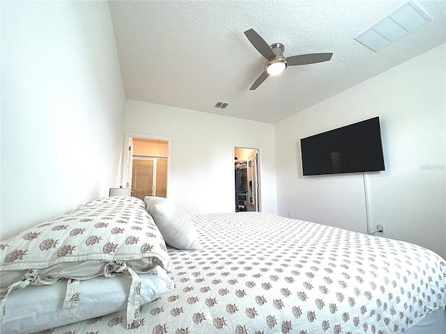 764 Richmond Estate Ave, Haines City, FL 33844 - bedroom featuring a walk in closet, a textured ceiling, and a ceiling fan
