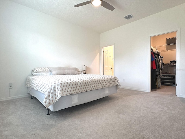 764 Richmond Estate Ave, Haines City, FL 33844 - carpeted bedroom with a walk in closet and a ceiling fan