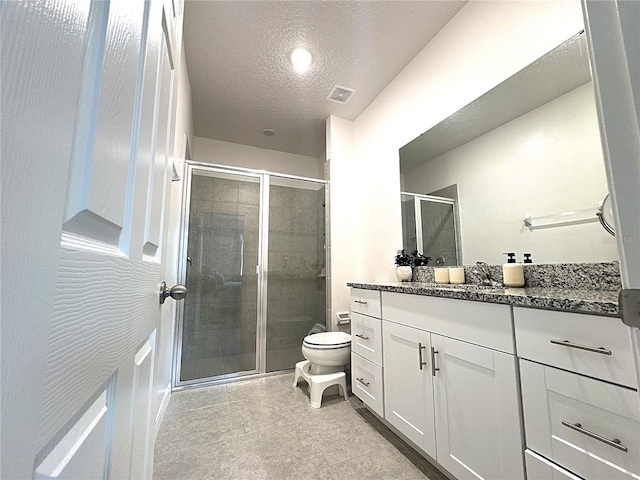 764 Richmond Estate Ave, Haines City, FL 33844 - bathroom with vanity, a shower stall, a textured ceiling, and tile patterned flooring
