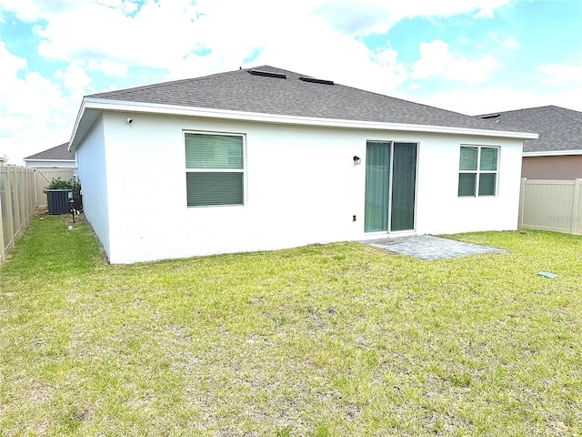 764 Richmond Estate Ave, Haines City, FL 33844 - back of property featuring a fenced backyard, stucco siding, and a shingled roof