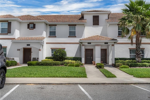 9005 Stinger Dr, Davenport, FL 33896 - mediterranean / spanish home featuring uncovered parking, a tiled roof, and stucco siding