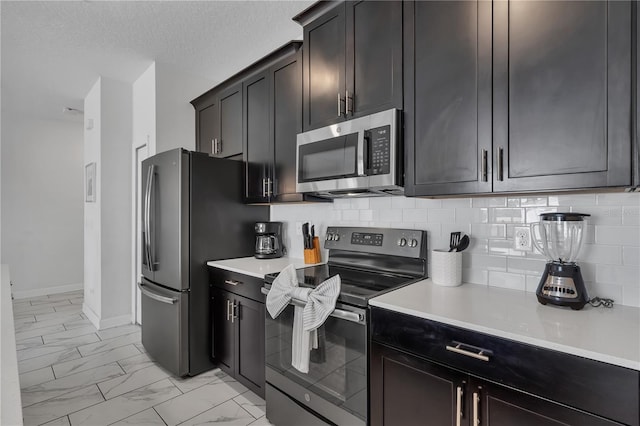 9005 Stinger Dr, Davenport, FL 33896 - kitchen with stainless steel appliances, light marble finish flooring, decorative backsplash, and light countertops