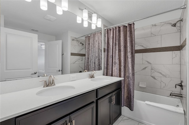 9005 Stinger Dr, Davenport, FL 33896 - full bathroom featuring marble finish flooring, shower / bath combo with shower curtain, and double vanity