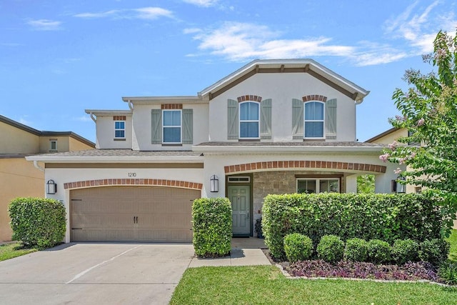 1210 Woods Landing Dr, Minneola, FL 34715 - view of front of home featuring stucco siding, driveway, and an attached garage
