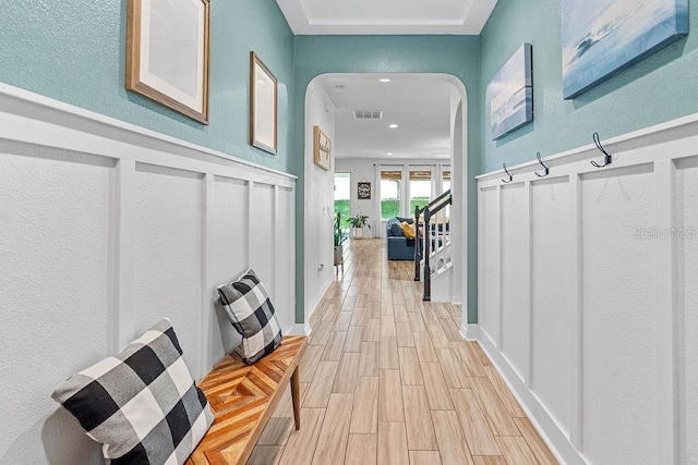 1210 Woods Landing Dr, Minneola, FL 34715 - corridor featuring arched walkways, light wood-style floors, recessed lighting, and a textured wall