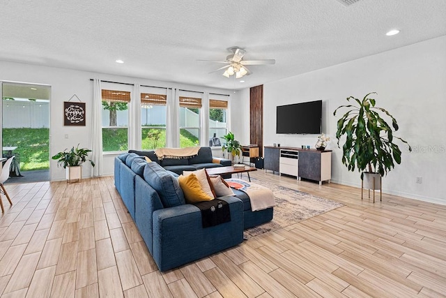 1210 Woods Landing Dr, Minneola, FL 34715 - living area with ceiling fan, light wood finished floors, a textured ceiling, and recessed lighting