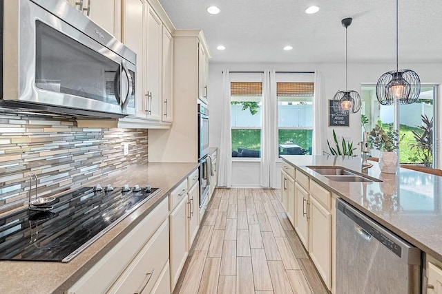 1210 Woods Landing Dr, Minneola, FL 34715 - kitchen with stainless steel appliances, backsplash, recessed lighting, light stone counters, and wood finish floors