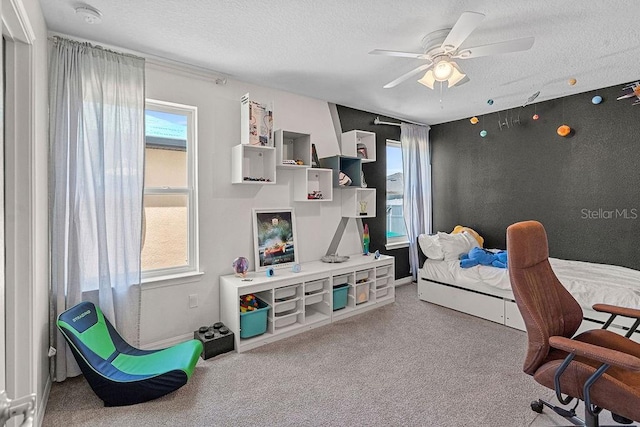 1210 Woods Landing Dr, Minneola, FL 34715 - bedroom featuring a textured ceiling, carpet floors, multiple windows, and a ceiling fan
