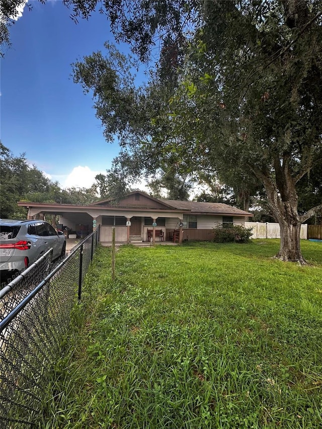 10004 Vaughn St, Gibsonton, FL 33534 - view of front of house with a fenced backyard and an attached carport