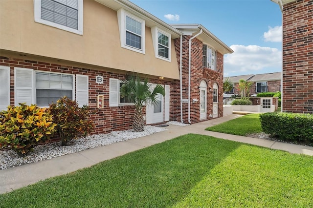 2200 S Palmetto Ave Unit B050, South Daytona, FL 32119 - view of front of house featuring a front lawn, brick siding, and stucco siding