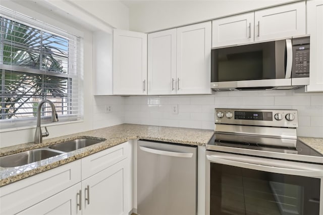 2200 S Palmetto Ave Unit B050, South Daytona, FL 32119 - kitchen featuring appliances with stainless steel finishes, white cabinets, and plenty of natural light