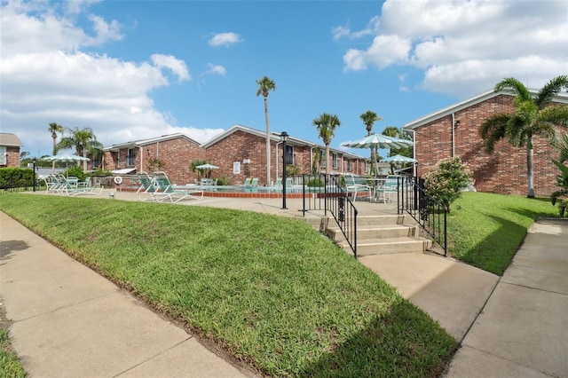 2200 S Palmetto Ave Unit B050, South Daytona, FL 32119 - view of property's community featuring a swimming pool, a yard, and a patio
