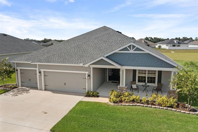 416 Riders Loop, Auburndale, FL 33823 - craftsman-style home with roof with shingles, covered porch, a front yard, an attached garage, and concrete driveway