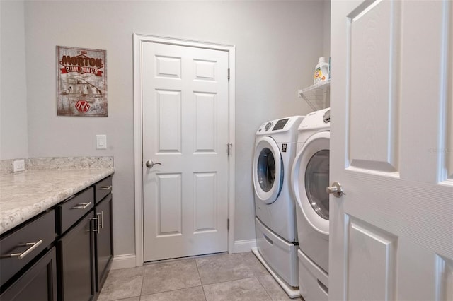 416 Riders Loop, Auburndale, FL 33823 - laundry room featuring separate washer and dryer, light tile patterned floors, and cabinet space