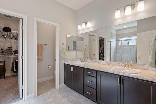 416 Riders Loop, Auburndale, FL 33823 - full bath with a spacious closet, double vanity, a stall shower, and tile patterned floors