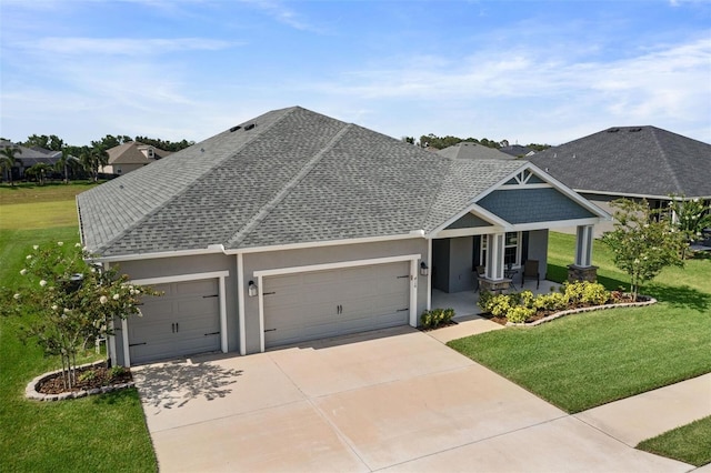 416 Riders Loop, Auburndale, FL 33823 - craftsman-style home featuring an attached garage, concrete driveway, covered porch, and a front lawn