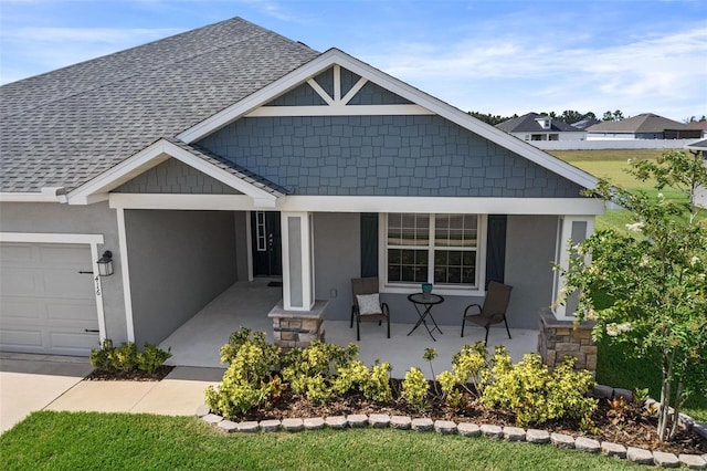 416 Riders Loop, Auburndale, FL 33823 - view of front of house featuring covered porch, a shingled roof, a garage, and stucco siding