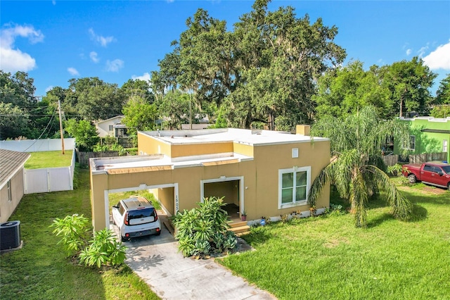 1505 E Elm Rd, Lakeland, FL 33801 - back of property with driveway, stucco siding, an attached carport, and view of scattered trees