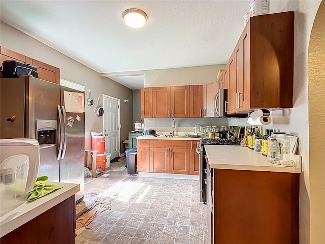 1505 E Elm Rd, Lakeland, FL 33801 - kitchen featuring appliances with stainless steel finishes, light countertops, and brown cabinetry