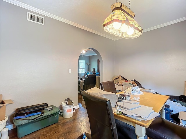 1505 E Elm Rd, Lakeland, FL 33801 - dining area featuring arched walkways, wood finished floors, and crown molding