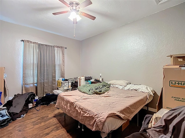 1505 E Elm Rd, Lakeland, FL 33801 - bedroom with wood finished floors, a ceiling fan, and a textured wall