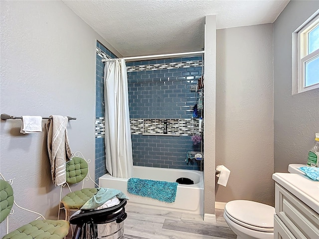 1505 E Elm Rd, Lakeland, FL 33801 - bathroom with wood finished floors, vanity, shower / bath combo, and a textured ceiling