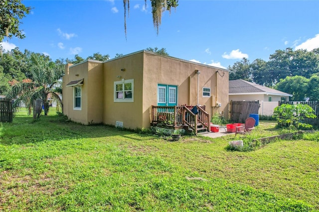 1505 E Elm Rd, Lakeland, FL 33801 - rear view of property featuring stucco siding and a wooden deck