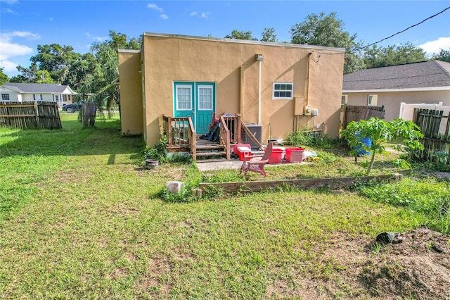 1505 E Elm Rd, Lakeland, FL 33801 - back of property featuring stucco siding and a deck