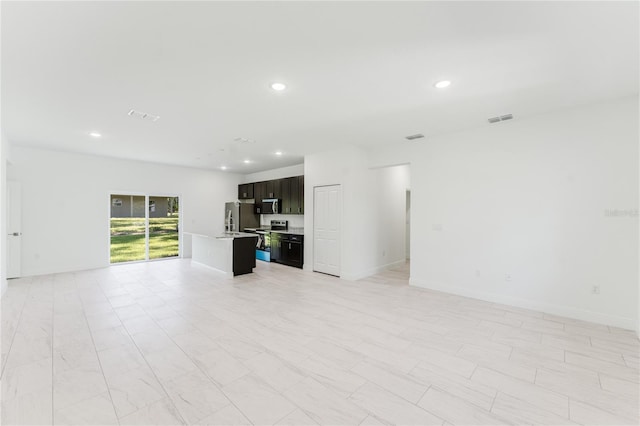 627 W Glenhaven Dr, Citrus Springs, FL 34434 - unfurnished living room featuring recessed lighting