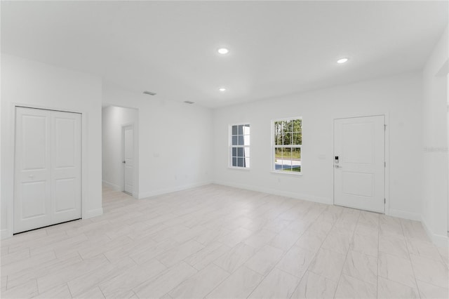 627 W Glenhaven Dr, Citrus Springs, FL 34434 - unfurnished living room with recessed lighting and baseboards