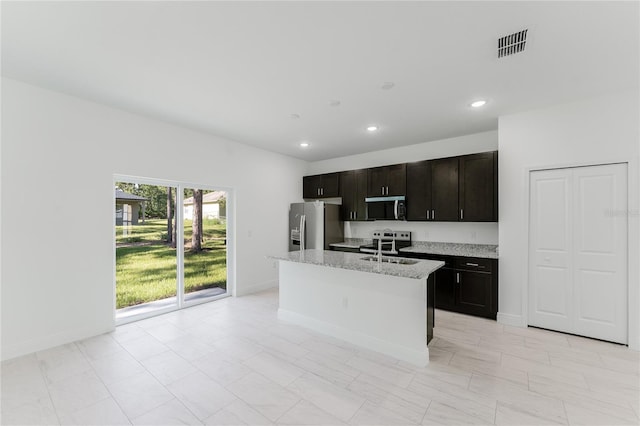 627 W Glenhaven Dr, Citrus Springs, FL 34434 - kitchen featuring appliances with stainless steel finishes, a center island with sink, recessed lighting, and light stone counters