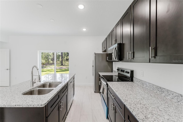 627 W Glenhaven Dr, Citrus Springs, FL 34434 - kitchen with stainless steel appliances, light marble finish floors, a center island with sink, light stone counters, and recessed lighting