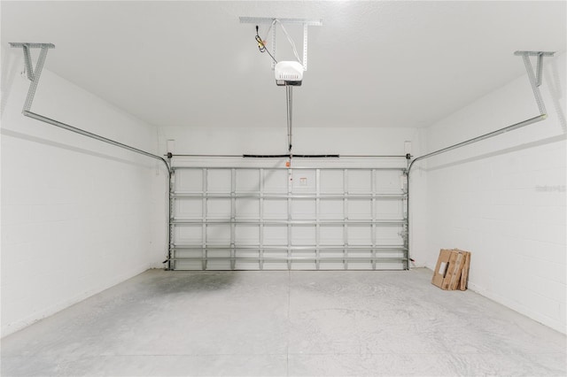 627 W Glenhaven Dr, Citrus Springs, FL 34434 - garage featuring a garage door opener and concrete block wall
