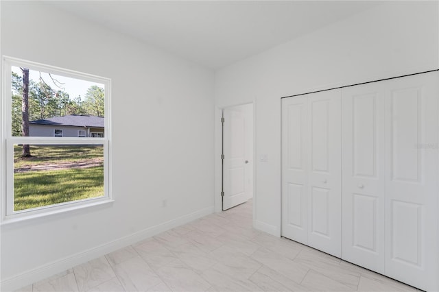 627 W Glenhaven Dr, Citrus Springs, FL 34434 - unfurnished bedroom featuring baseboards and a closet