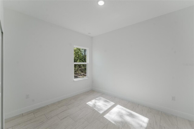 627 W Glenhaven Dr, Citrus Springs, FL 34434 - empty room with baseboards and recessed lighting