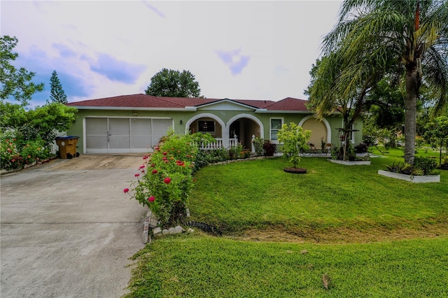 317 Cortez Ct, Kissimmee, FL 34758 - view of front of house featuring stucco siding, concrete driveway, an attached garage, and a front yard