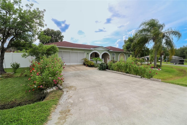 317 Cortez Ct, Kissimmee, FL 34758 - mediterranean / spanish home featuring concrete driveway, a garage, and stucco siding