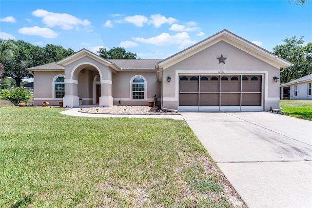 12617 Douglas Fir Ct, Clermont, FL 34711 - single story home with stucco siding, driveway, a front yard, and a garage
