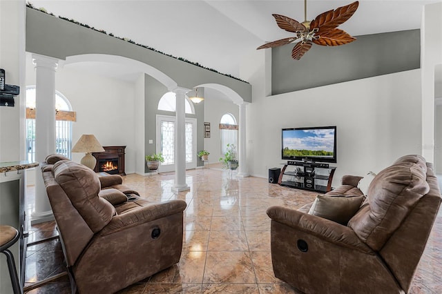 12617 Douglas Fir Ct, Clermont, FL 34711 - living area with decorative columns, plenty of natural light, arched walkways, a high ceiling, and a ceiling fan