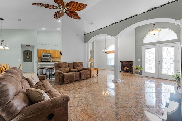 12617 Douglas Fir Ct, Clermont, FL 34711 - living area featuring a high ceiling, ornate columns, arched walkways, a ceiling fan, and french doors