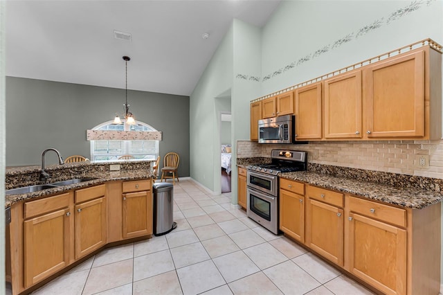 12617 Douglas Fir Ct, Clermont, FL 34711 - kitchen with appliances with stainless steel finishes, high vaulted ceiling, decorative backsplash, light tile patterned flooring, and decorative light fixtures