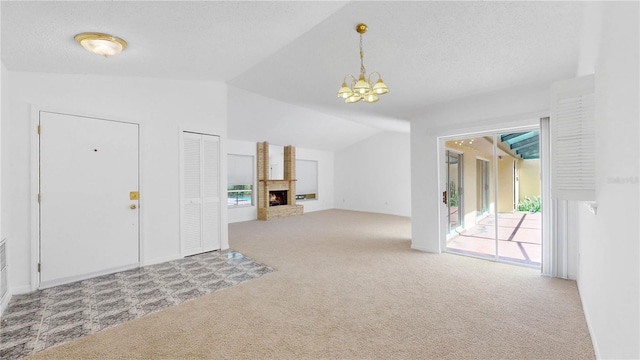 5045 Bermuda Cir Unit 12, Orlando, FL 32808 - foyer entrance featuring carpet flooring, lofted ceiling, a chandelier, a fireplace, and a textured ceiling