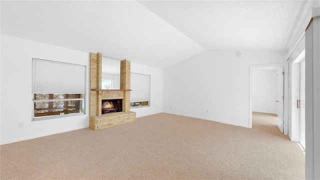 5045 Bermuda Cir Unit 12, Orlando, FL 32808 - unfurnished living room with carpet floors, lofted ceiling, and a fireplace