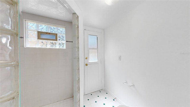 5045 Bermuda Cir Unit 12, Orlando, FL 32808 - doorway to outside featuring light tile patterned flooring and baseboards